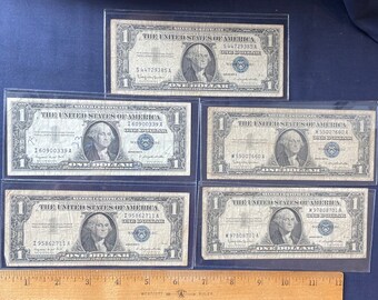 Vintage lot of 5 silver certificates 1957 series A & B circulated in protective sleeves