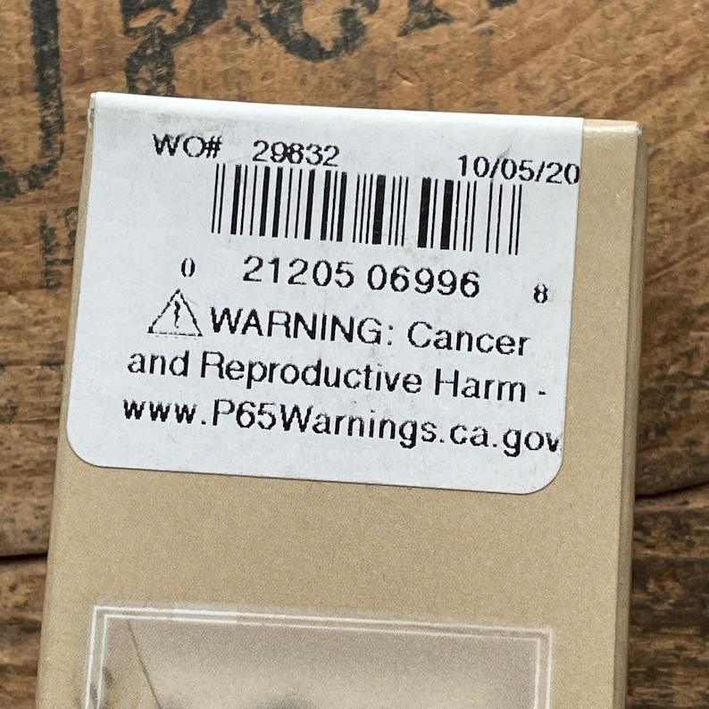 May include: A rectangular tan cardboard box featuring a white adhesive label with a barcode, the text WO# 29832, the date 10/05/20, and a California Proposition 65 warning stating: WARNING: Cancer and Reproductive Harm - www.P65Warnings.ca.gov.