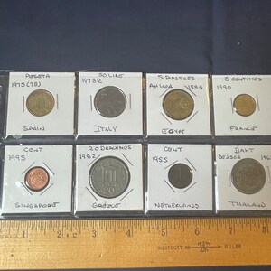 Vintage 8 coin lot Spain, Italy, Thailand, Netherlands, Greece, Egypt, Singapore and France in protective sleeves.
