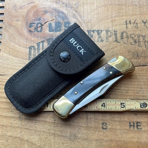 Buck USA model 110 brass Lockback 1 blade pocket knife w/ sheath
