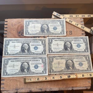 Vintage lot of 5 silver certificates 1957 circulated in protective sleeves