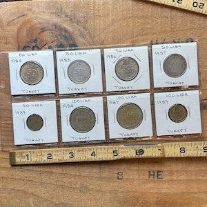 Vintage 8 coin lot Turkey 1980's 50 & 100 Lira in protective sleeves.