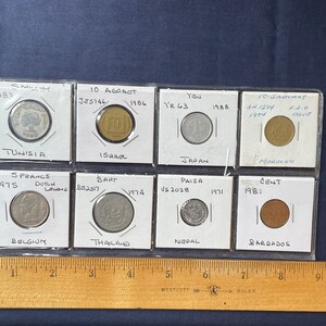 Vintage 8 coin lot Belgium, Tunisia, Japan & others in protective sleeves.