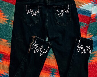 jeans with flames at the bottom