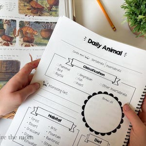 May include: A spiral-bound educational worksheet titled Daily Animal with sections for classification, habitat, and a drawing space. The page features checkboxes for animal types like mammal, bird, and reptile, alongside a list of habitats.