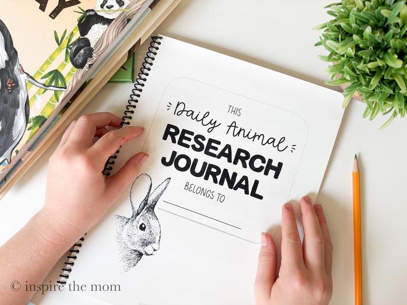 May include: A spiral-bound Daily Animal RESEARCH JOURNAL with a white cover featuring black text and a detailed black and white illustration of a rabbit head. The cover includes the printed text THIS Daily Animal RESEARCH JOURNAL BELONGS TO.