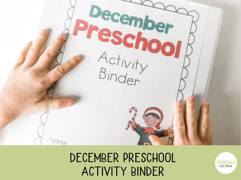 May include: A white activity binder for December Preschool, with the title in red and teal. The cover features a cartoon elf holding a candy cane. The binder is held by two hands.