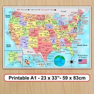 May include: A colorful map of the United States of America featuring state boundaries, capitals, major cities, and volcanoes. The map includes insets for Alaska and Hawaii, a compass rose, and the American flag. Text indicates Printable A1 - 23 x 33 inches.