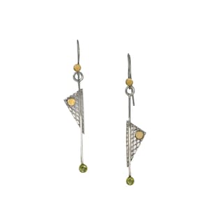 May include: Silver and gold geometric dangle earrings with green gemstones. The earrings feature a textured triangle shape with a gold circle accent.