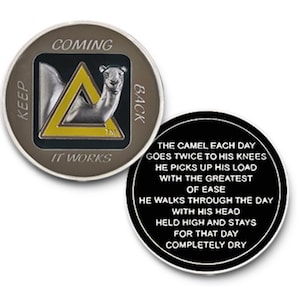 May include: A silver coin with a camel and a triangle on one side and a poem about a camel on the other side. The poem reads: "The camel each day goes twice to his knees he picks up his load with the greatest of ease he walks through the day with his head held high and stays for that day completely dry"