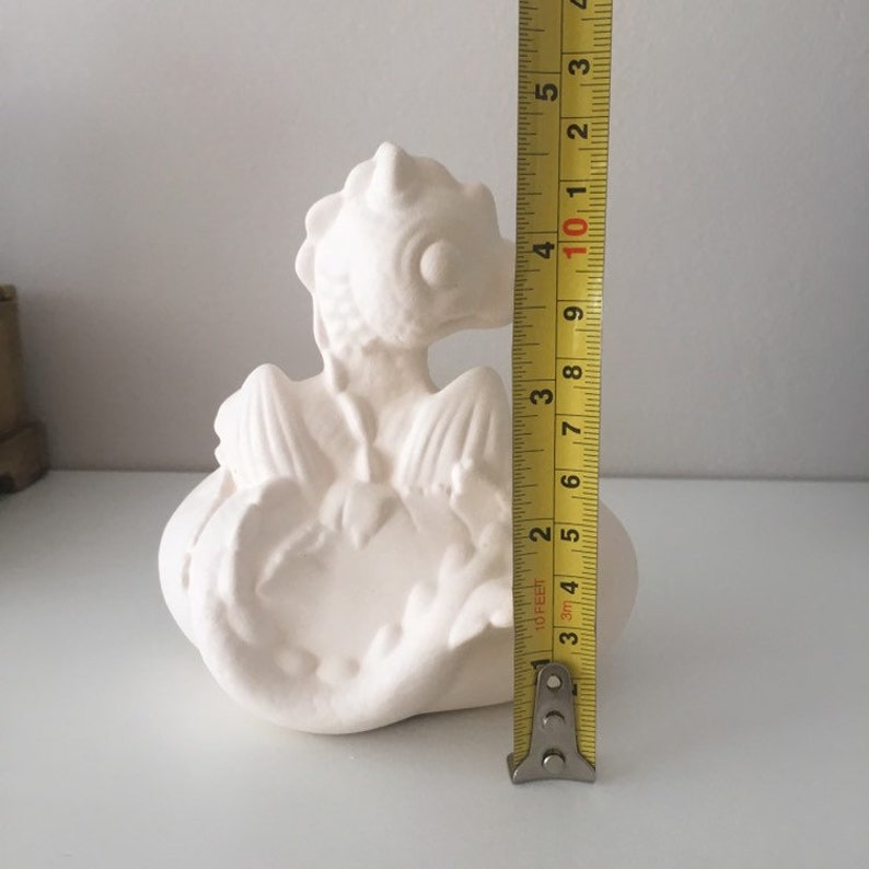 May include: White ceramic dragon figurine sitting on a cloud-shaped base. The dragon is approximately 4 inches tall.