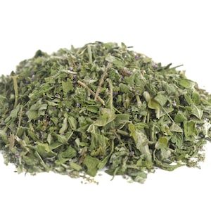 May include: A pile of dried green and purple herbs, likely for use in cooking or herbal remedies.