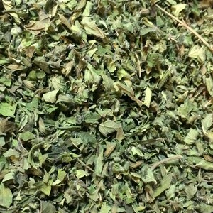 May include: A close-up of dried green herbs, likely for culinary or medicinal use.