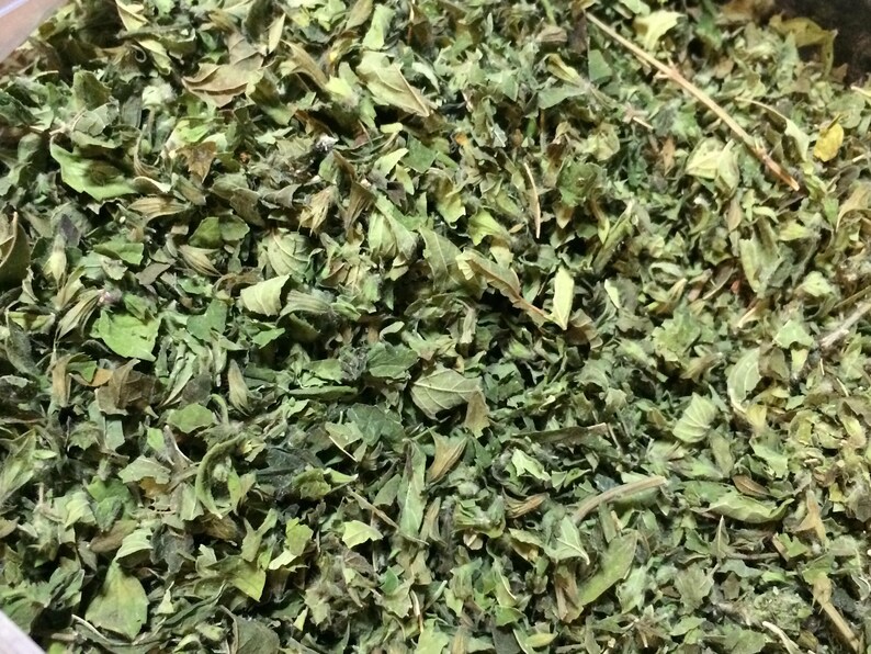 May include: A close-up of dried green herbs, likely for culinary or medicinal use.