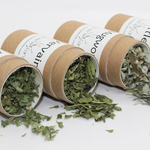 May include: Four cardboard tubes filled with dried herbs, labeled "Harmony", "Everair", "Mugwort", and "Nettle".
