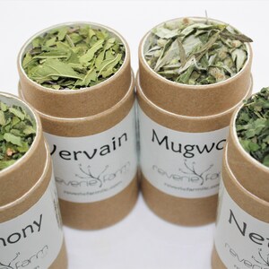 May include: Four brown cardboard tubes filled with dried herbs. The tubes are labeled "Agrimony", "Vervain", "Mugwort", and "Nettles".