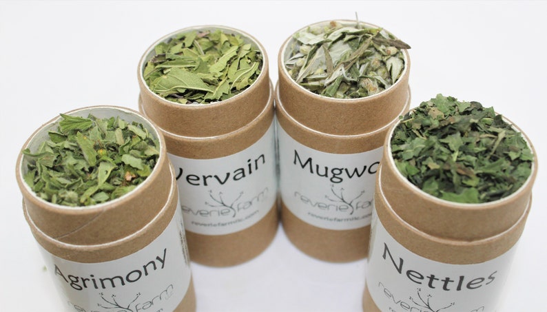 May include: Four brown cardboard tubes filled with dried herbs. The tubes are labeled "Agrimony", "Vervain", "Mugwort", and "Nettles".
