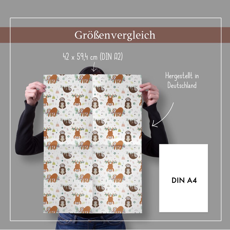May include: A person is holding a white poster with a repeating pattern of brown sloths hanging from branches. The poster is folded in half and the text "42 x 59,4 cm (DIN A2)" is visible at the top. The text "Hergestellt in Deutschland" is visible on the right side of the poster. A smaller white poster with the text "DIN A4" is visible on the right side of the image.