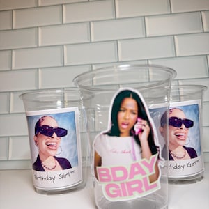 May include: Transparent plastic cups featuring images of a woman wearing sunglasses and the text "Birthday Girl '95". One cup has a sticker that says "BDAY GIRL" in pink and green.
