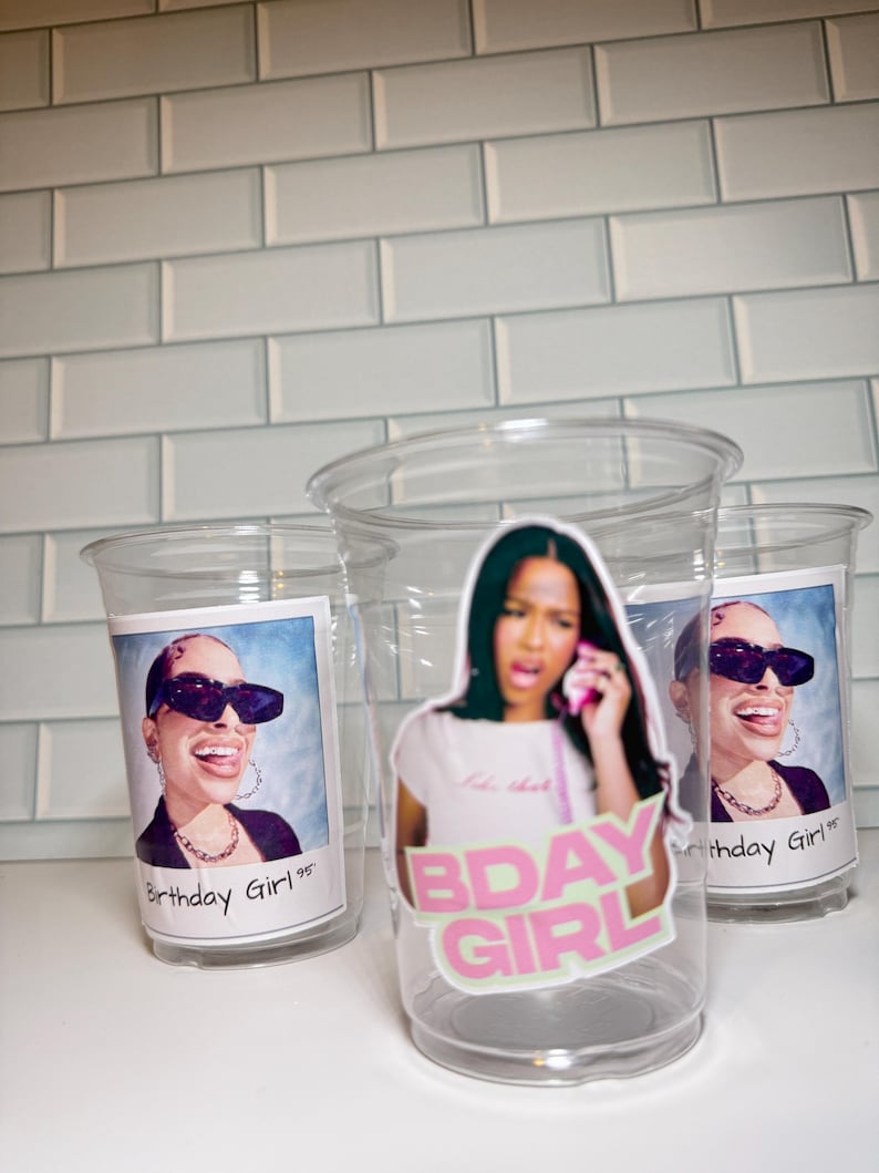 May include: Transparent plastic cups featuring images of a woman wearing sunglasses and the text "Birthday Girl '95". One cup has a sticker that says "BDAY GIRL" in pink and green.