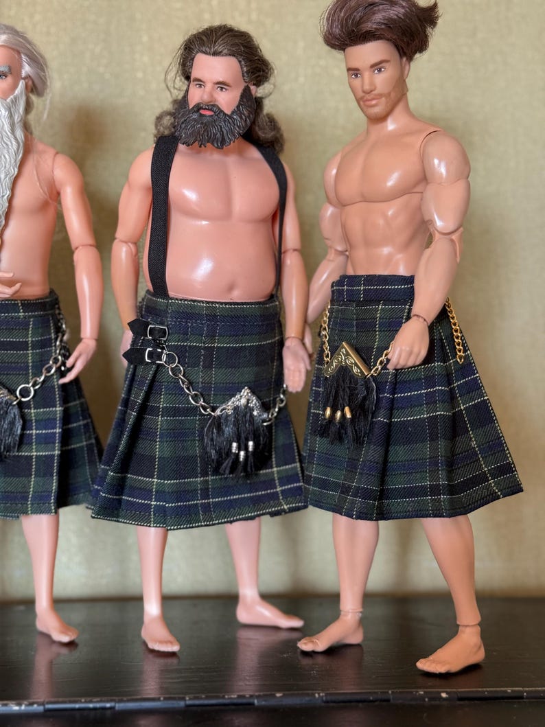 May include: Three male dolls with muscular builds wearing traditional-style kilts in a dark green, blue, and black plaid pattern. Each doll features a small sporran accessory attached with a gold or silver chain, and the central doll wears black suspenders.