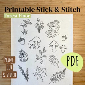 May include: A printable PDF with line drawings of woodland items, such as mushrooms, acorns, leaves, and a pine cone. The text "Printable Stick & Stitch Forest Floor" is at the top, with "Print, Cut & Stitch" and "PDF" also displayed.