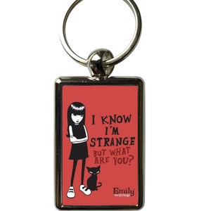 May include: A rectangular keyring with a silver metal frame and ring. The red background features a black illustration of a girl and a cat, with the text "I KNOW I'M STRANGE BUT WHAT ARE YOU?" and the name "Emily the Strange".