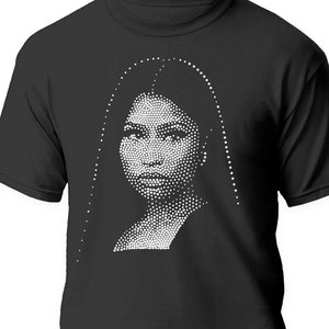 May include: Black t-shirt featuring a white image of a woman's face made of dots.