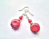 Red and blue patterned ceramic earrings made from Kenyan Kazuri fair trade, hand made and hand painted beads