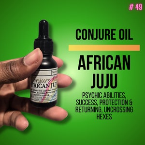 May include: A small, dark brown glass bottle with a dropper top. The bottle is labelled "Conjure Oil African Juju" and lists uses for protection, success, returning, and uncrossing. The bottle is held in a hand against a green background. #49