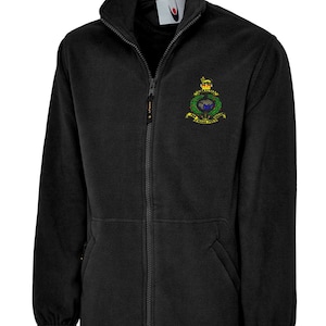 May include: Black fleece jacket with a full zip, high collar, and two front pockets. A colourful emblem is embroidered on the chest. The jacket is designed for warmth and comfort.