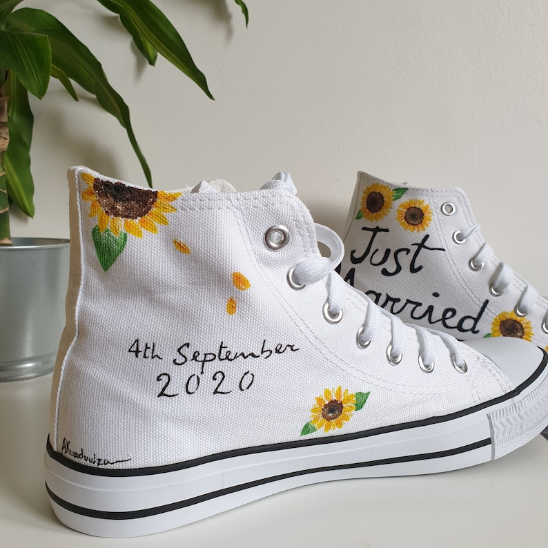 May include: White high-top canvas shoes with a sunflower design and the text "Just Married" and "4th September 2020" painted on them.