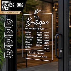 May include: A white business hours decal for a boutique, applied to a glass door. The decal includes the boutique's name, business hours, a phone number, and website address. Additional icons indicate weather resistance, ease of application, and a professional look.