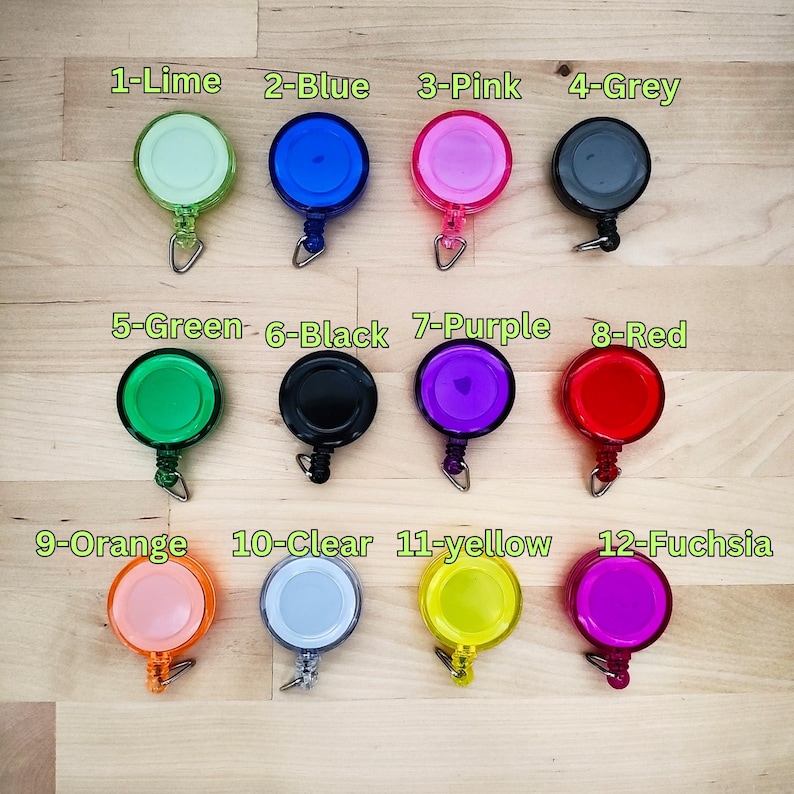 May include: Twelve retractable badge holders in various colours, including lime, blue, pink, grey, green, black, purple, red, orange, clear, yellow, and fuchsia.