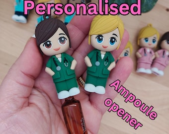 May include: Two personalised green and white nurse figurines with brown and blonde hair, holding a small brown glass bottle with a dropper. The text "Personalised" and "Ampoule opener" is visible in the image.