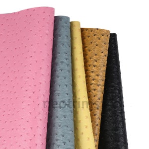 May include: Five different colors of faux ostrich leather fabric swatches. The colors are pink, gray, yellow, brown, and black.