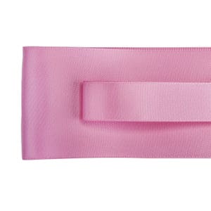 May include: A pink satin ribbon with a textured surface.