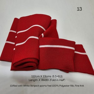 Peut inclure: Tissu tricot&eacute; rouge avec des rayures blanches. Le tissu mesure 112 cm de long et 13 cm de large. Le tissu est en c&ocirc;te 100% polyester, fin tricot&eacute;.