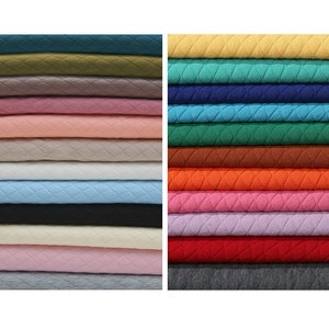 May include: A stack of 18 different colored fabric swatches. The fabric has a quilted diamond pattern. The colors include green, pink, beige, blue, black, white, red, orange, brown, and gray.