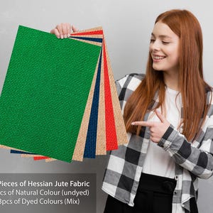 May include: Six pieces of hessian jute fabric, three natural and three dyed in assorted colours. The fabric is displayed in a stack, with the natural fabric on top and the dyed fabric underneath.