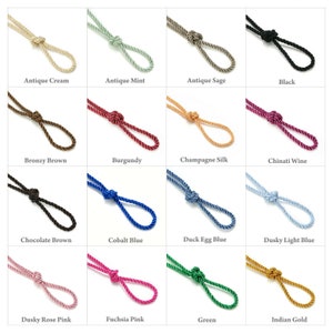 May include: A collection of 18 different colours of twisted rope cord, each tied in a loop. The colours include antique cream, antique mint, antique sage, black, bronzy brown, burgundy, champagne silk, chinati wine, chocolate brown, cobalt blue, duck egg blue, dusky light blue, dusky rose pink, fuchsia pink, green, and Indian gold.