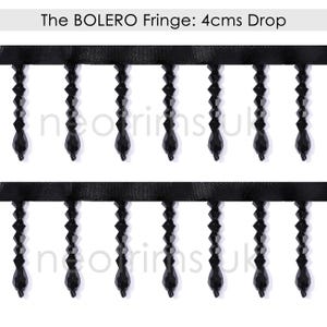 May include: Black beaded fringe trim with a 4 cm drop. The fringe is made of small, faceted beads that are strung together to create a delicate and elegant look. The trim is perfect for adding a touch of glamour to any project.