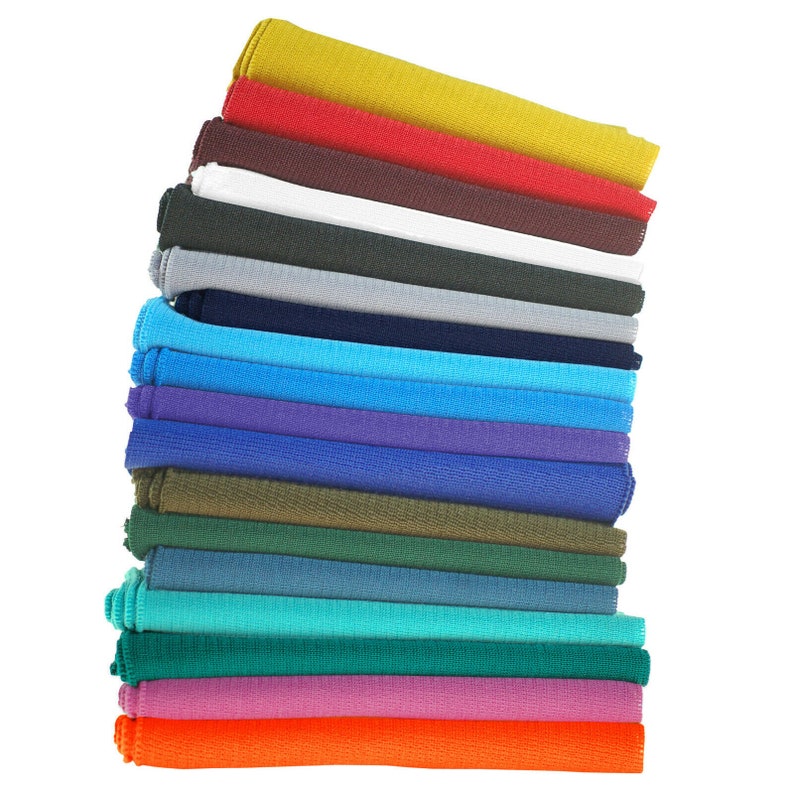 May include: A stack of 18 colorful fabric swatches, folded and arranged in a vertical pile. The swatches are in various shades of blue, green, purple, orange, red, and yellow.