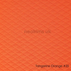 May include: Tangerine orange fabric with a diamond pattern. The fabric is textured and has a subtle sheen.