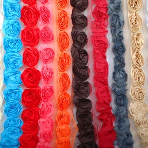 May include: Assortment of 12 colors of fabric trim with a 3D rose design. The trim is made of a soft, sheer fabric and is perfect for adding a touch of elegance to any project.