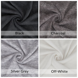 Op de afbeelding: Vier stofstalen in verschillende kleuren: zwart, antraciet, zilvergrijs en off-white. De stof is een zachte, gestructureerde brei.