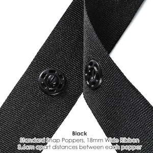 May include: Black ribbon with two black snap poppers, 18mm wide, spaced 3.6cm apart.  Standard Snap Poppers, 18mm Wide Ribbon 3.6cm apart distances between each popper