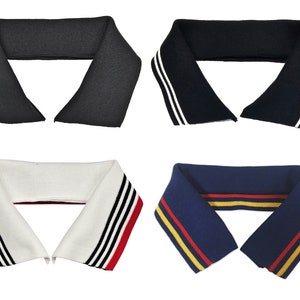 May include: Four different collar inserts for a polo shirt. The inserts are made of a knit fabric and have different colored stripes. The first insert is black, the second is navy blue with white stripes, the third is white with black and red stripes, and the fourth is navy blue with red and yellow stripes.