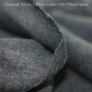 May include: Close-up of charcoal gray fabric with a tubular width of 160-170cm open. The fabric is soft and textured.