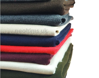 May include: A stack of folded fabric in various colors, including gray, brown, blue, beige, navy, red, burgundy, white, green, and black.